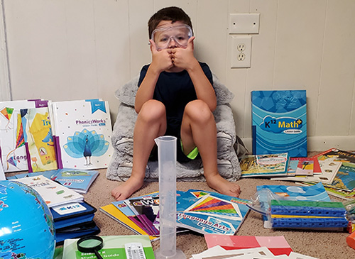 boy playing with books and toys