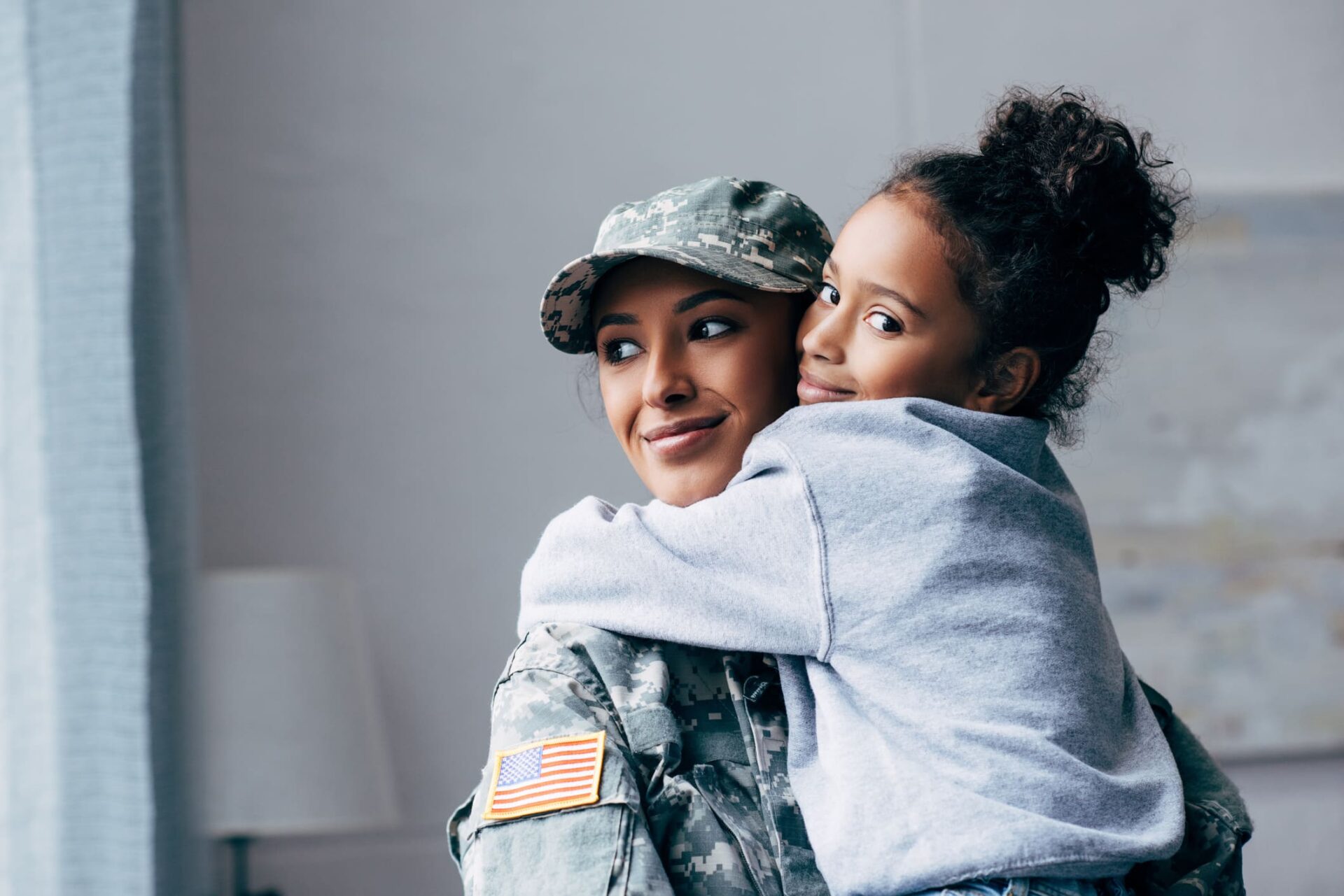 Military woman holding a girl