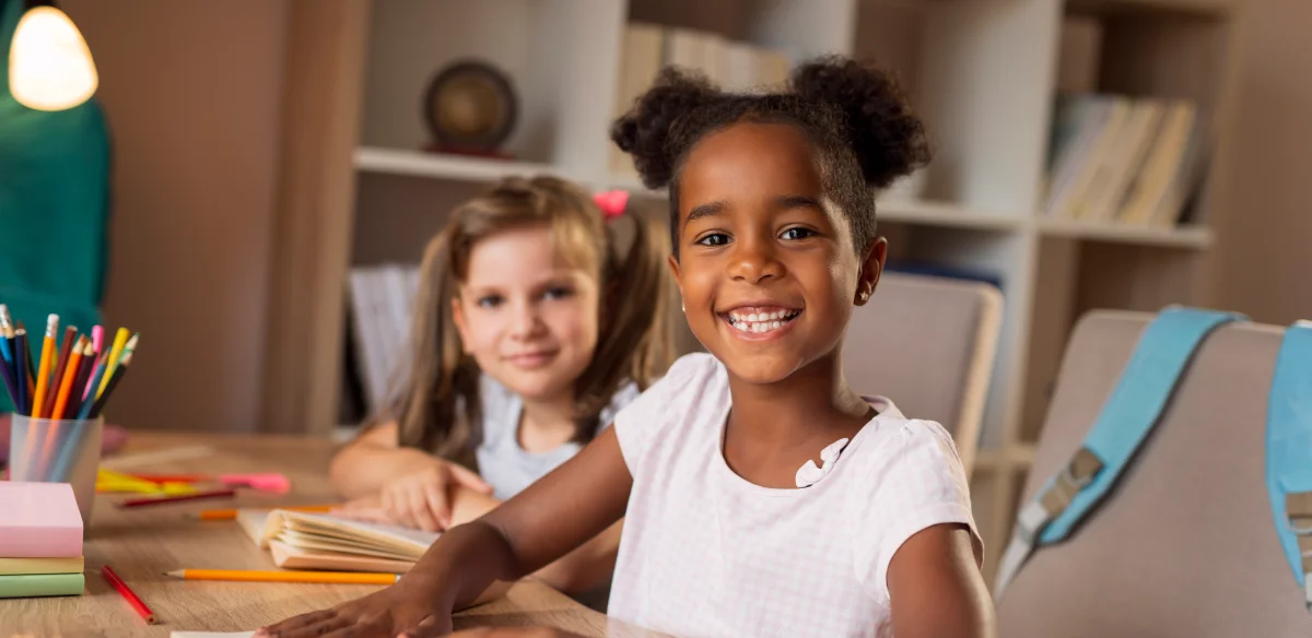 Two elementary students smiling at the camera