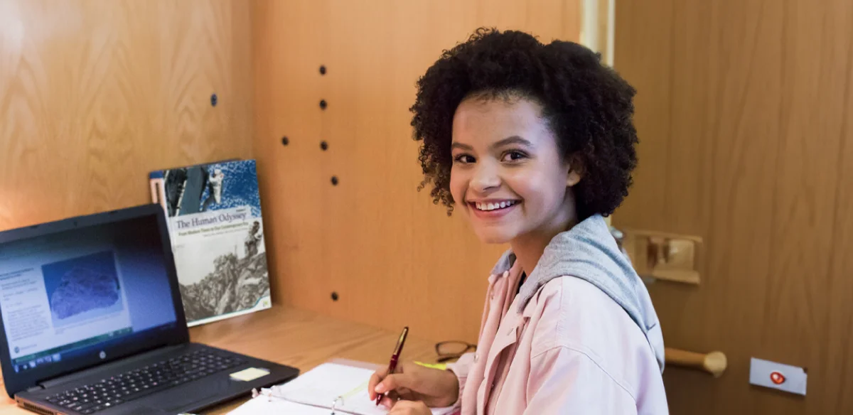 Student taking notes from her laptop