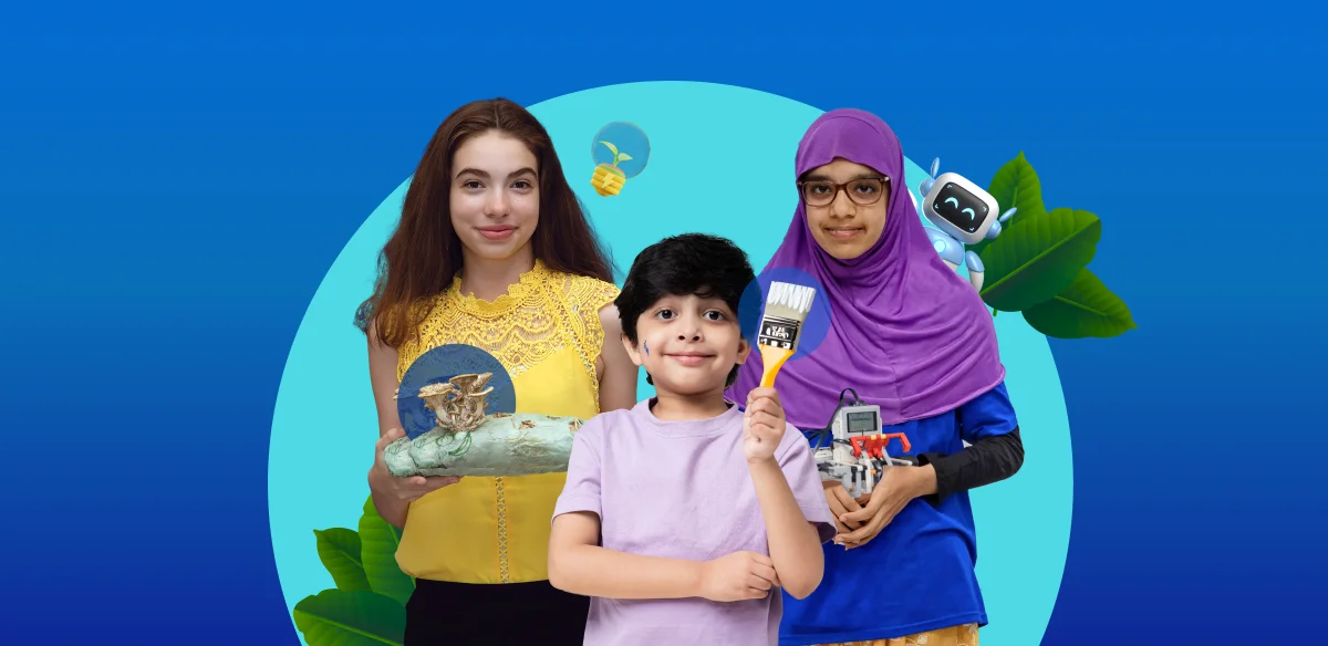 A girl holding an art project, a boy with a brush and a girl holding a small robot