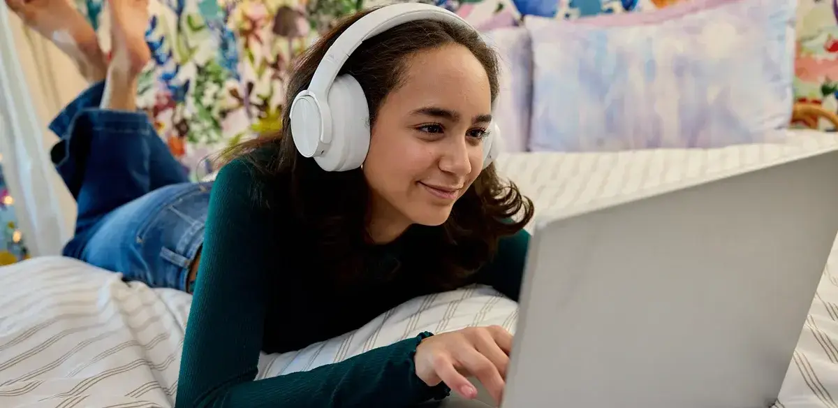 girl smiling and using her computer