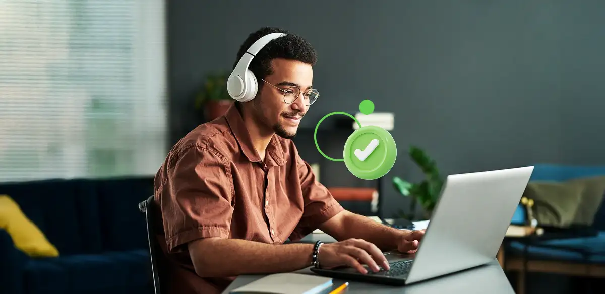 Student attending to an online class wearing a white pair of headphones